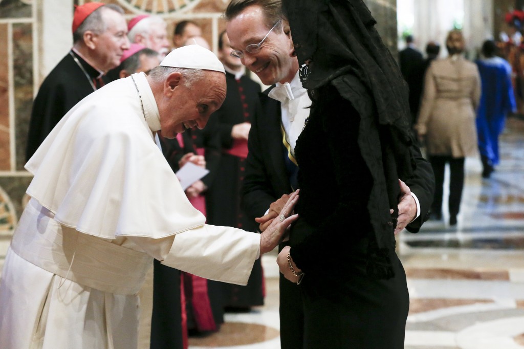 Pope Francis greets an ambassador and his wife during an audience with the diplomatic corps at the Vatican Jan.11. (CNS photo/Alessandro Bianchi, Reuters) See POPE-DIPLOMATS Jan. 11, 2015.